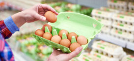 Mujer comprando huevos en el supermercado